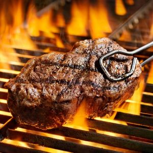 sirloin steak cooking on a fire grill