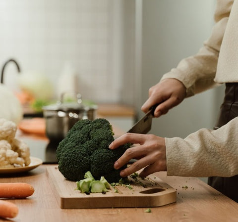 is hickory good for cutting boards- Person chopping vegetables on wooden cutting board