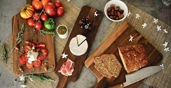 three cutting boards with cheese and meatloafon them