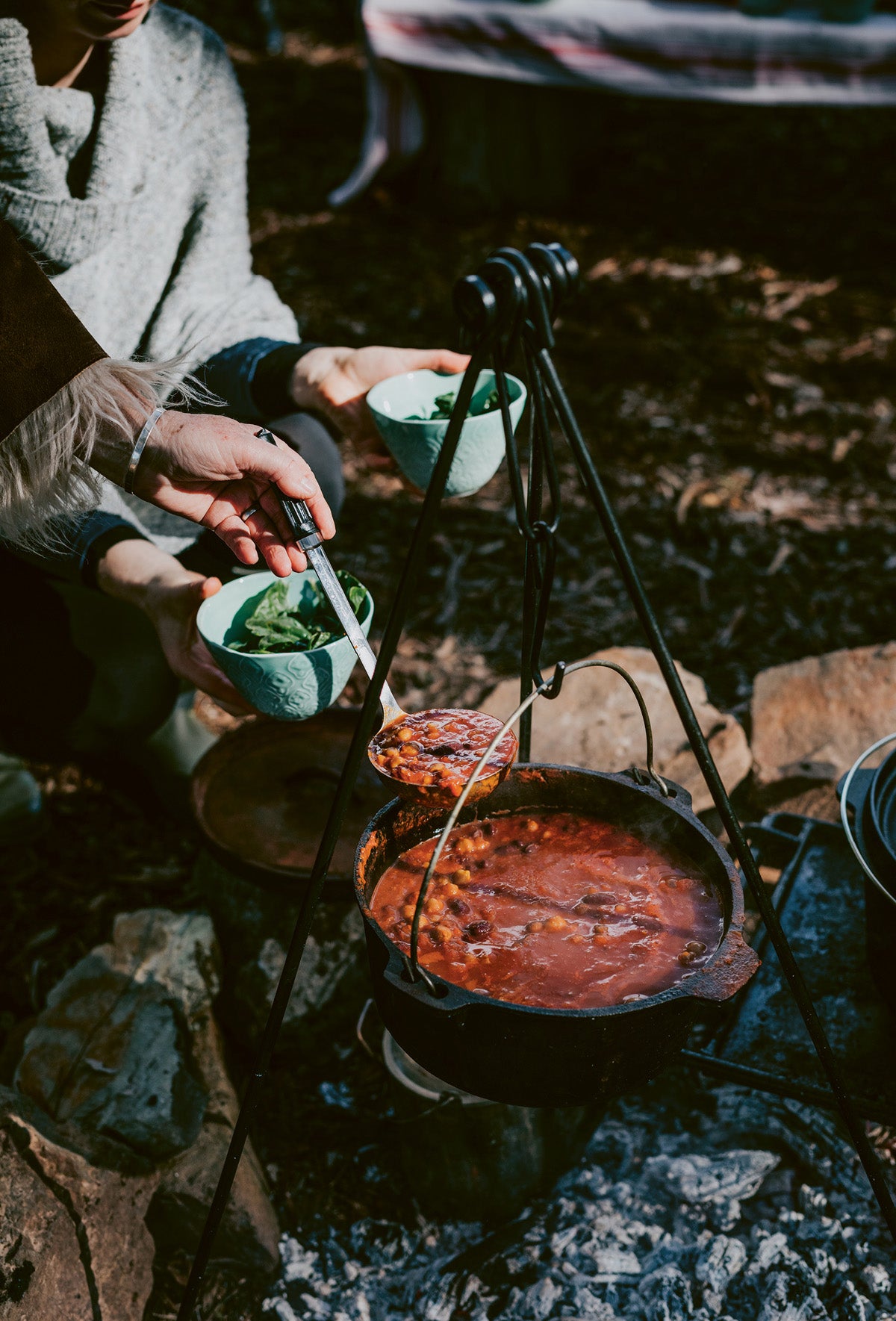 A bean stew cooking over an open fire