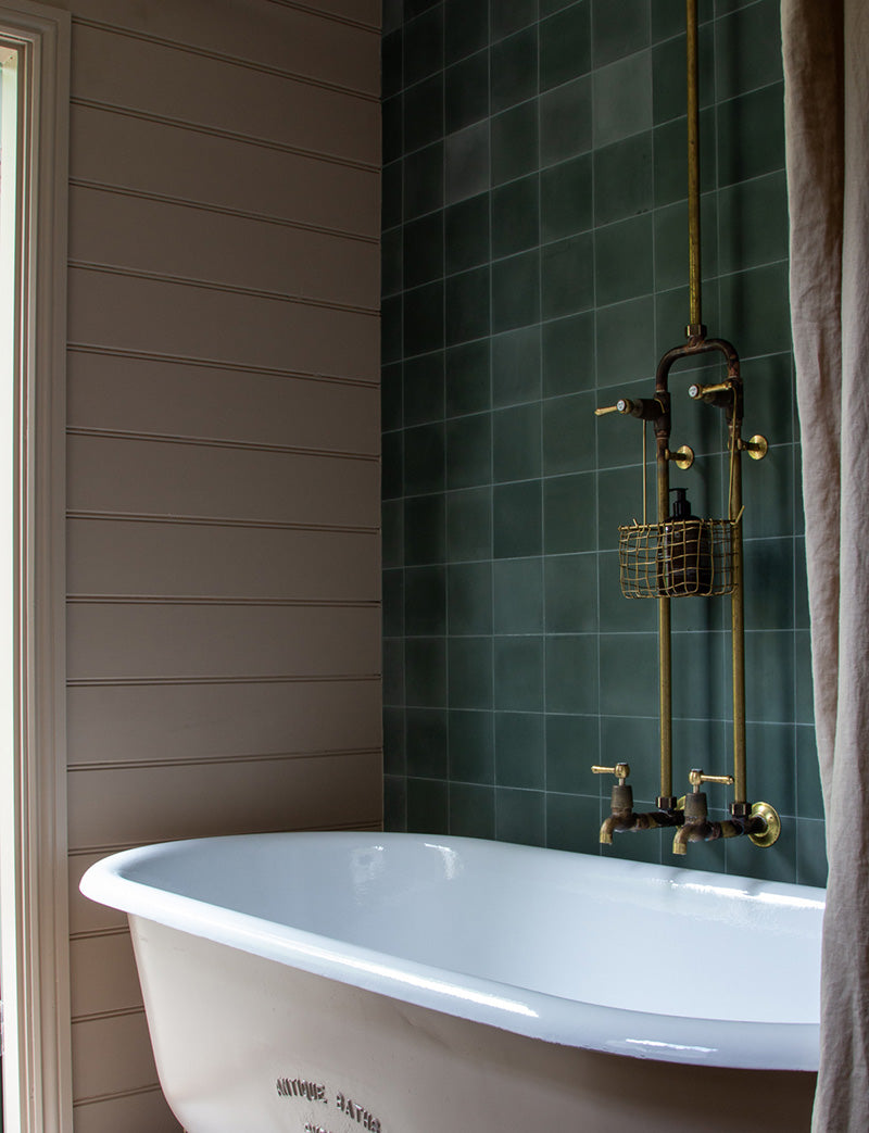 Vintage bath tub and brass tapware