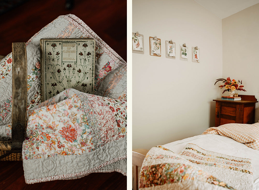 A vintage bedroom scene in  country cottage. An embroidered quilt sits on the bed. There is a vase with Autumn flowers on the bedside table.