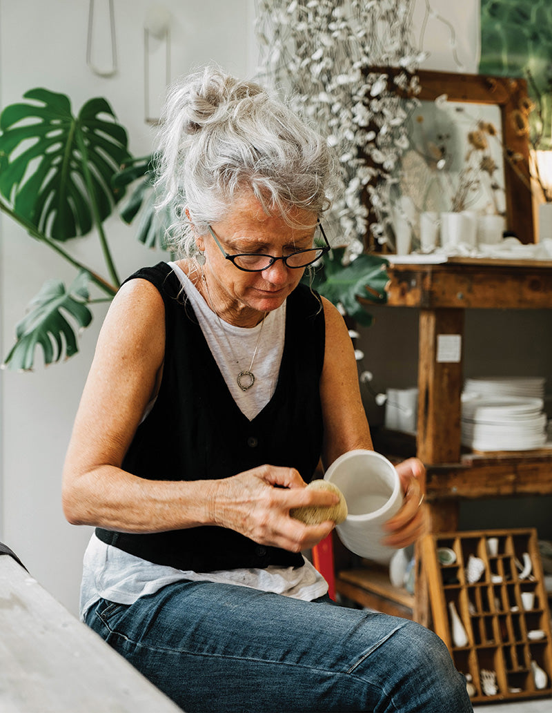 Porcelain artist Jo Victoria working on Southern Wild Co's candle vessels.