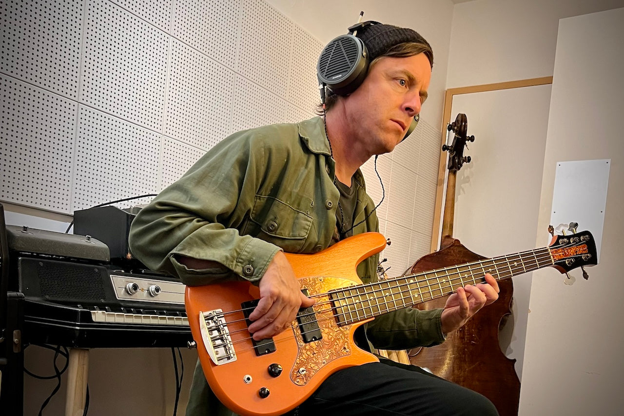 Billy wearing Audeze MM-500 headphones playing the bass