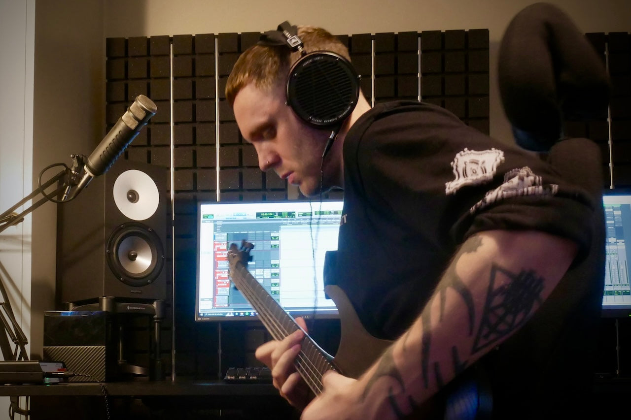 Buster Odeholm wearing Audeze LCD-X headphones playing the guitar