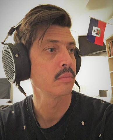 Ches Smith in his home with his LCD-X headphones