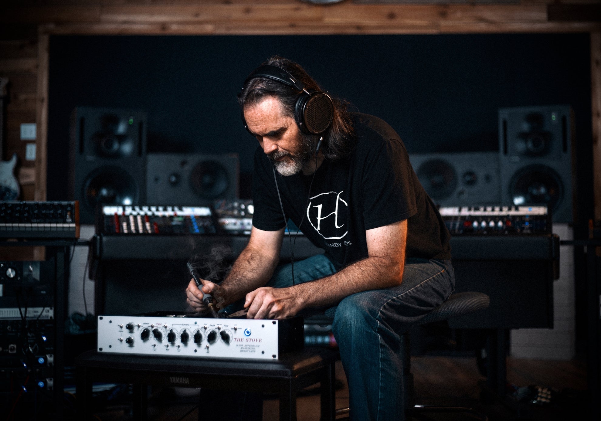 Chirs Henderson works on a piece of gear with his Audeze LCD-X headphones