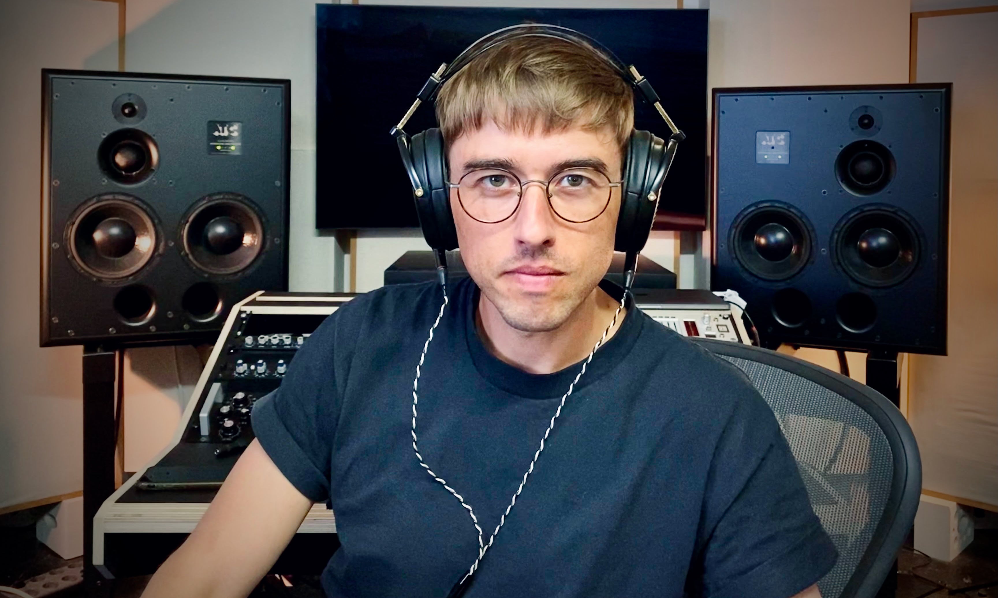 Mathias Schober poses in front of his workstation with his LCD-4z headphones