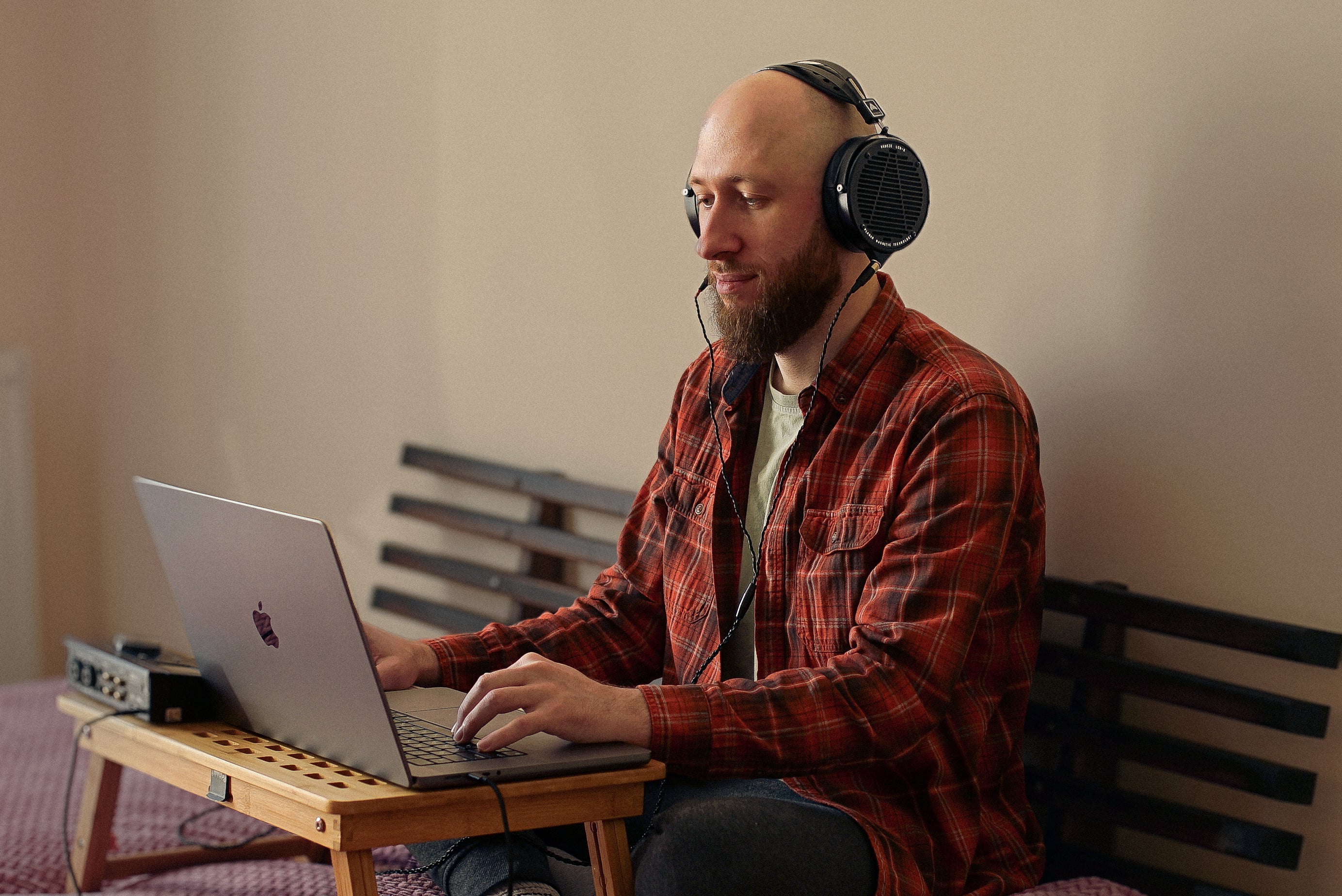 Oleg Yershov in his workspace wearing Audeze LCD-X Headphones