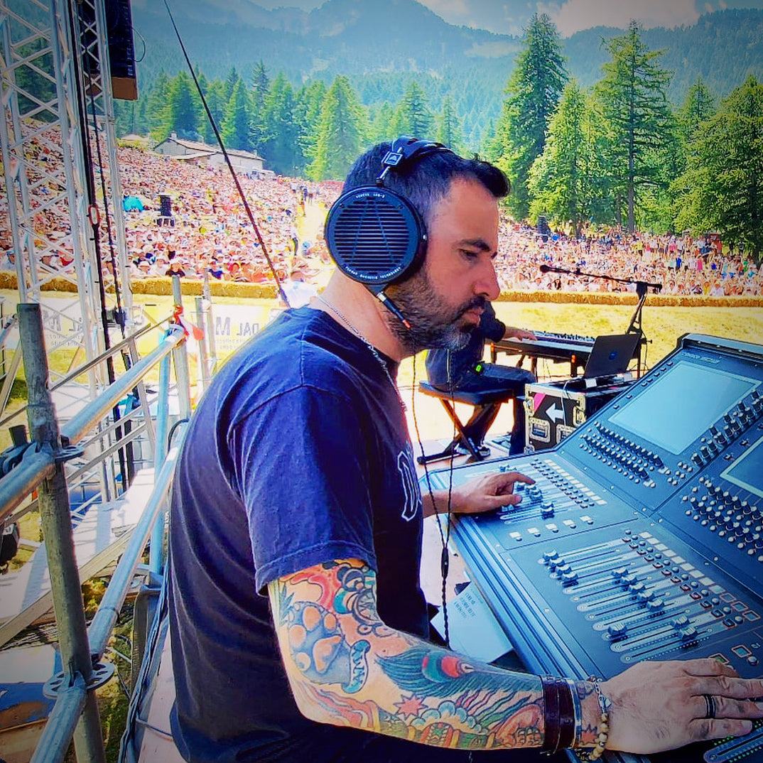 Ricky Carioti mixing an outdoor concert with his Audeze LCD-X headphones