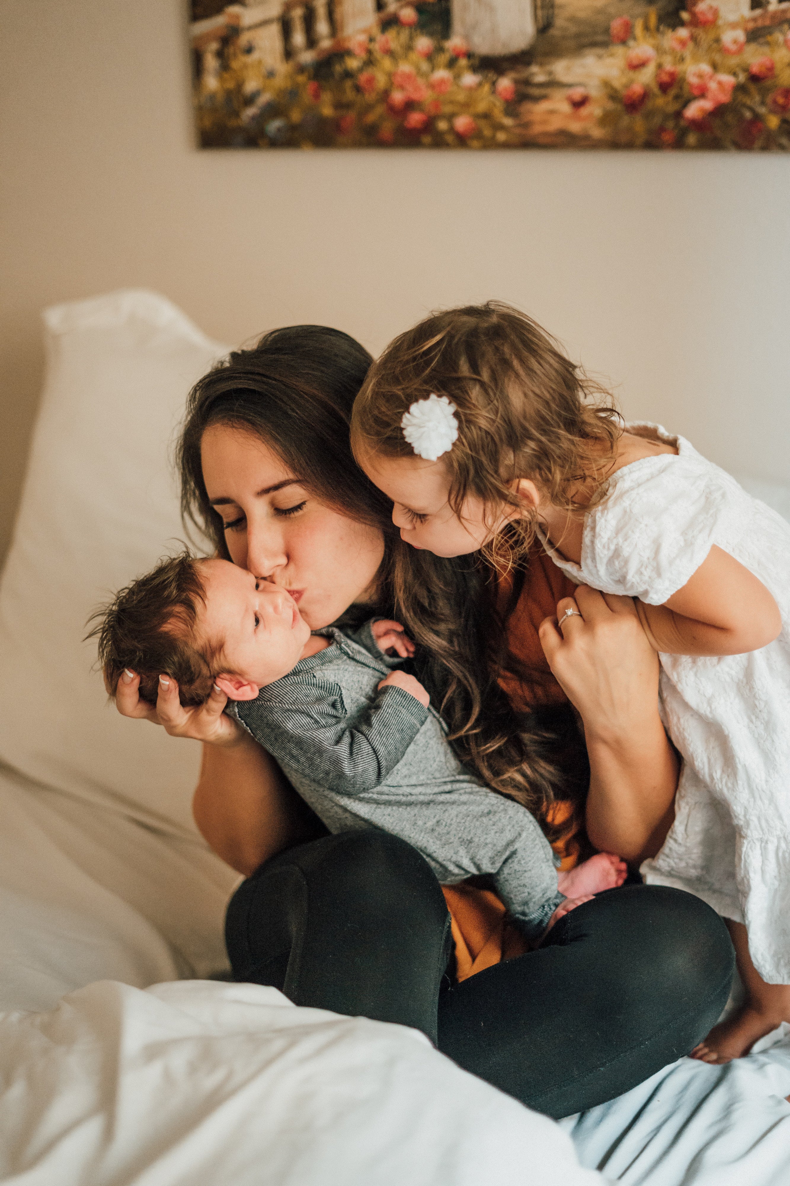 Family Sharing Sweet Moment with Big Sister Kissing Baby Brother
