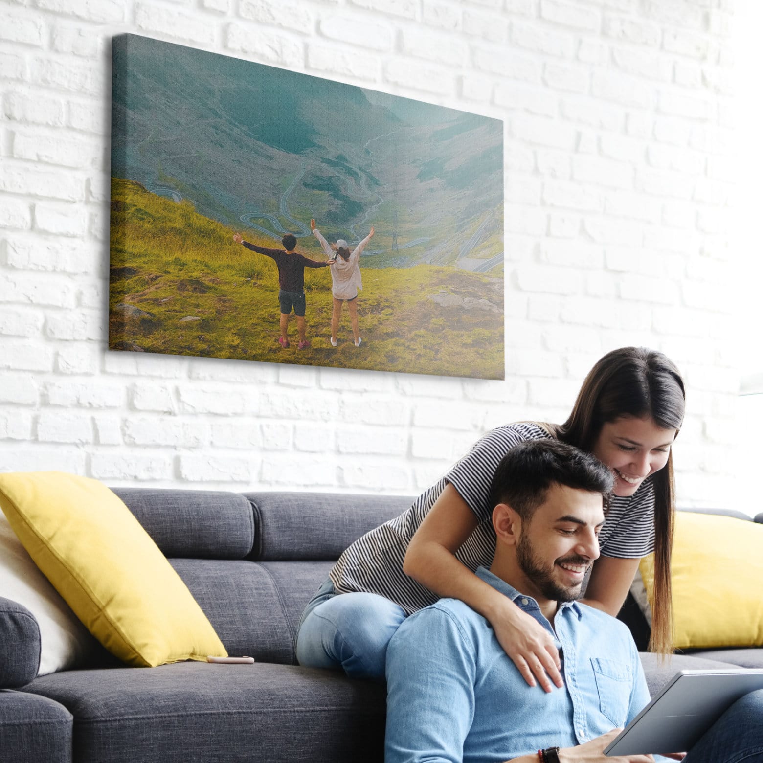 A couple looking on a laptop, exploring the best places to get photos printed on canvas.