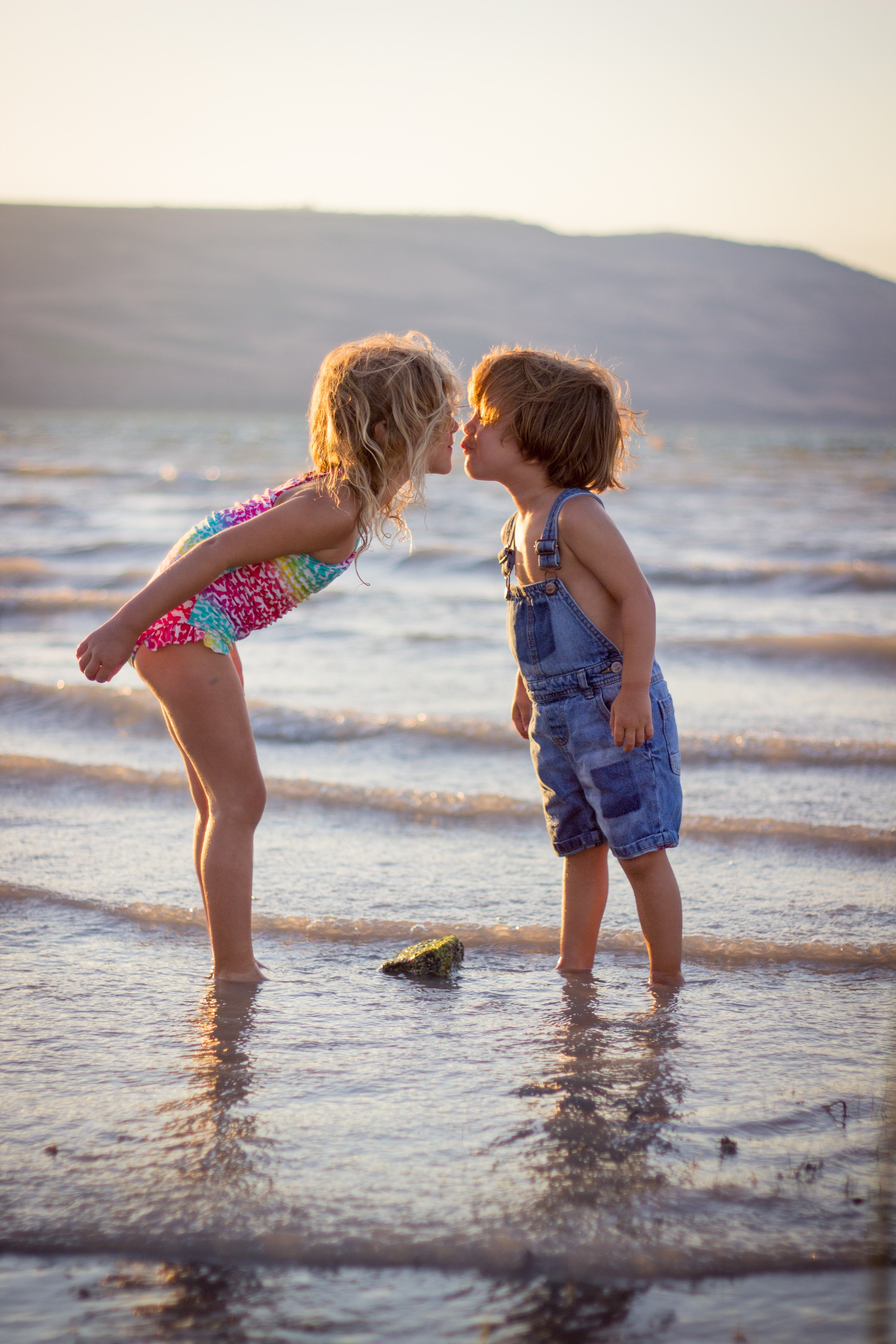 Young Siblings Kissing on The Beach