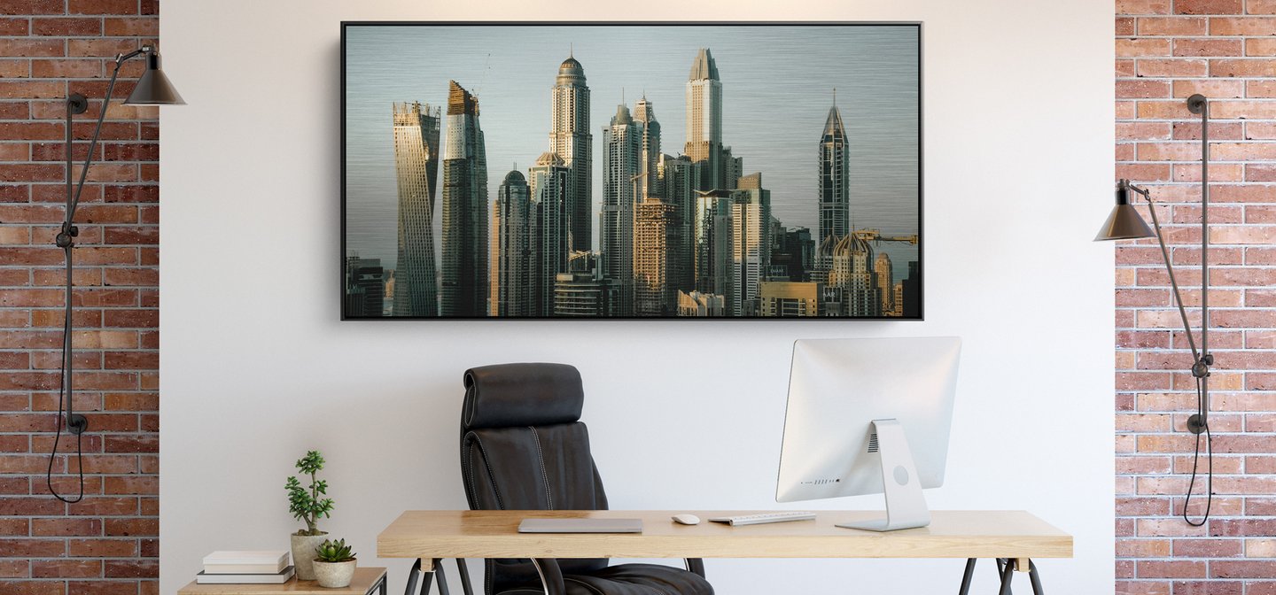 Brushed Metal Photo Print of a Cityscape Displayed on a Wall in a Home Office