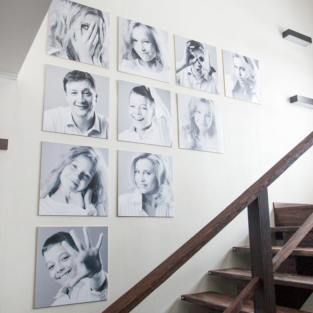 Black and white family portraits displayed in a stairway
