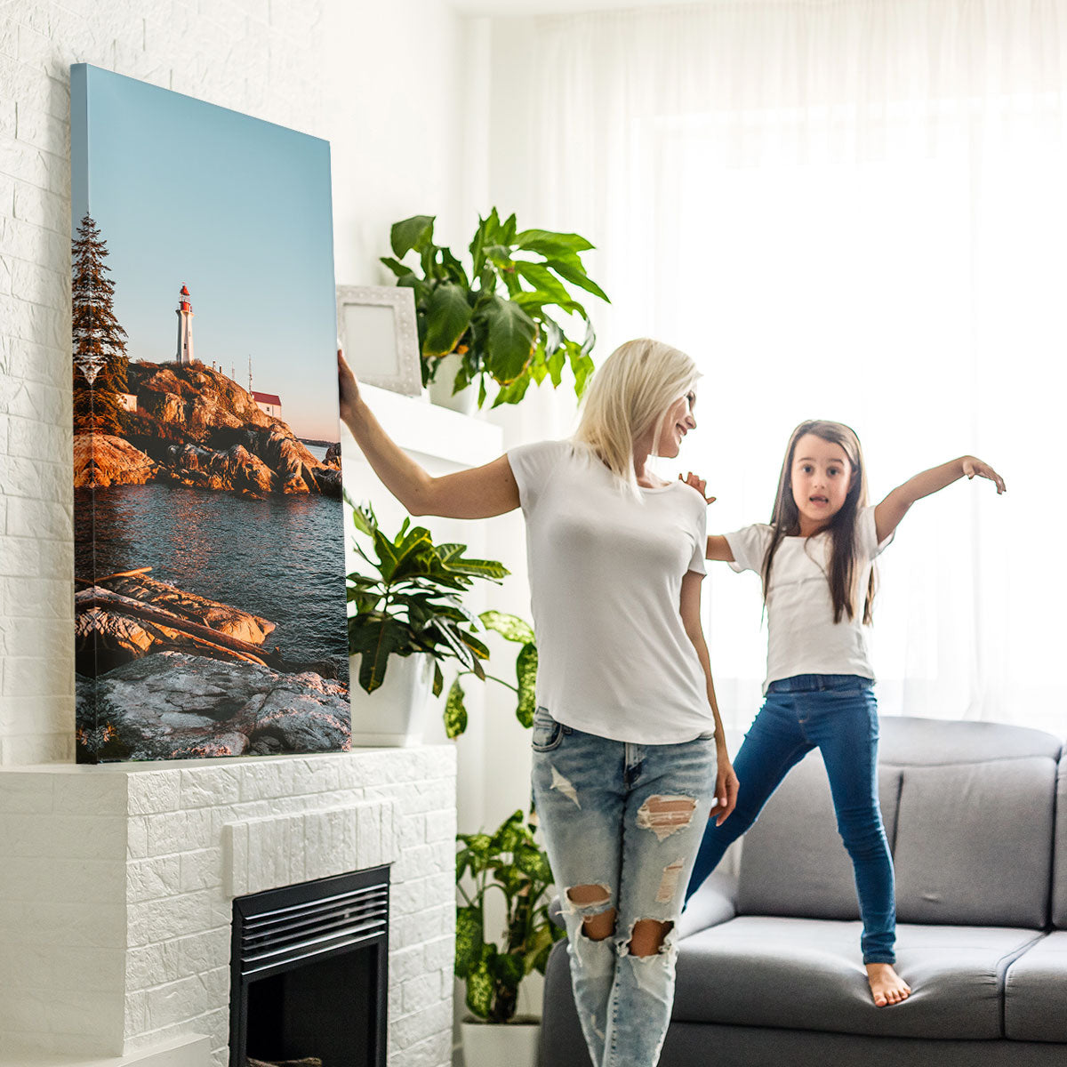 Canadian mom and daughter in living room with large canvas photo print.