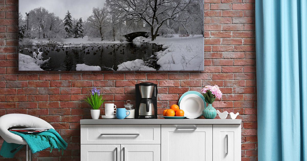Large Canvas Print of a black & white photo displayed against a brick wall in a kitchen with teal decor