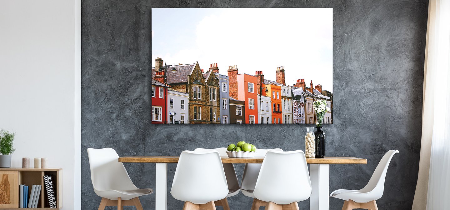 Photo of Colourful Houses Printed on Metal by Posterjack and Displayed Above a Dining Room Table