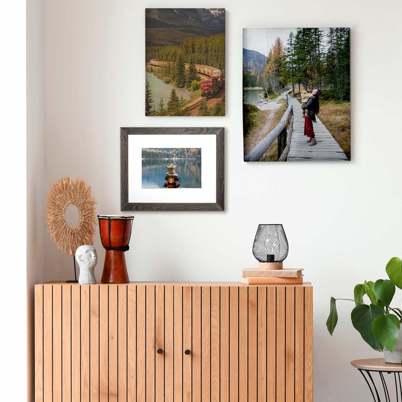 Three pictures arranged on the wall, different sizes and materials.