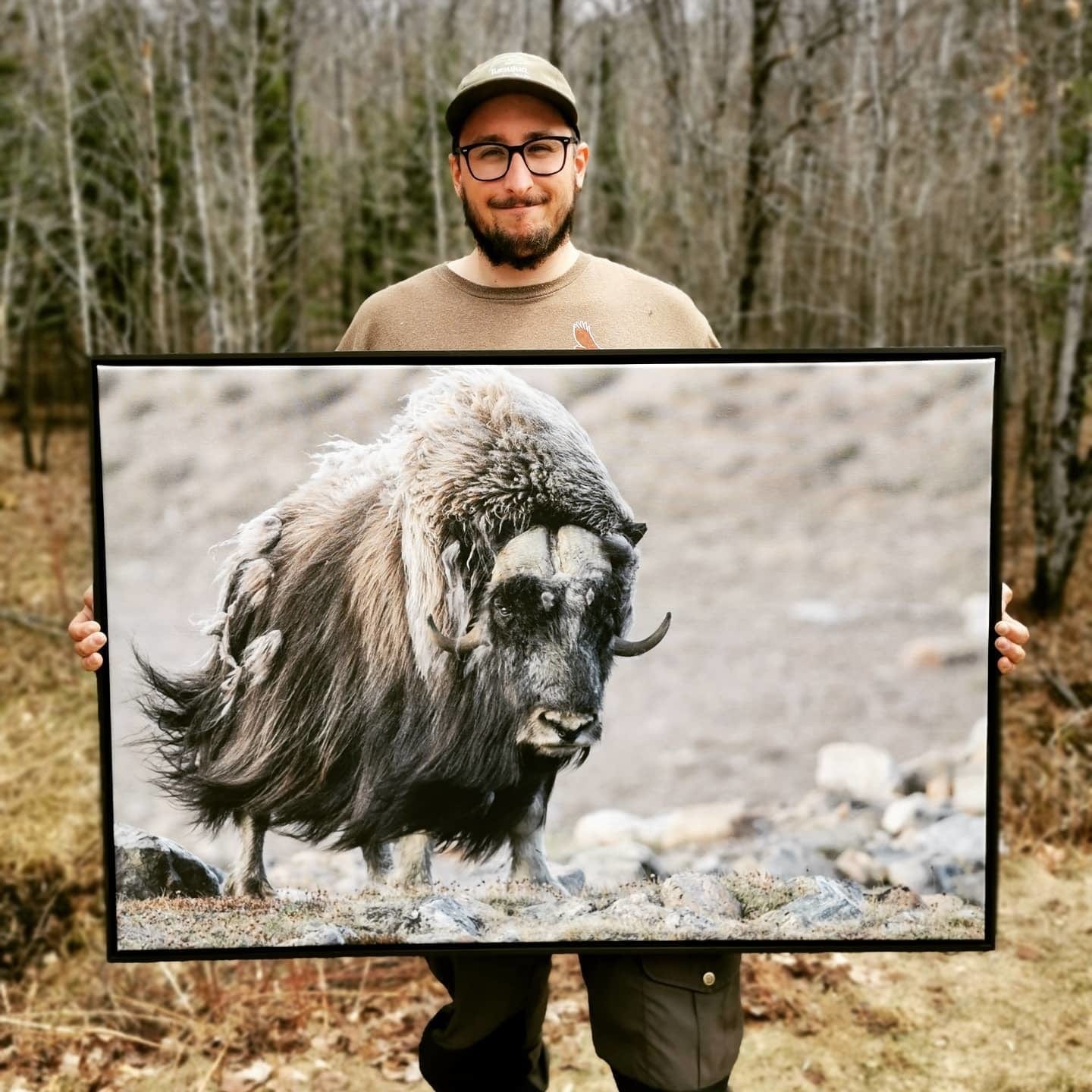 Posterjack Canada customer holding their large photo print of a wildlife image.