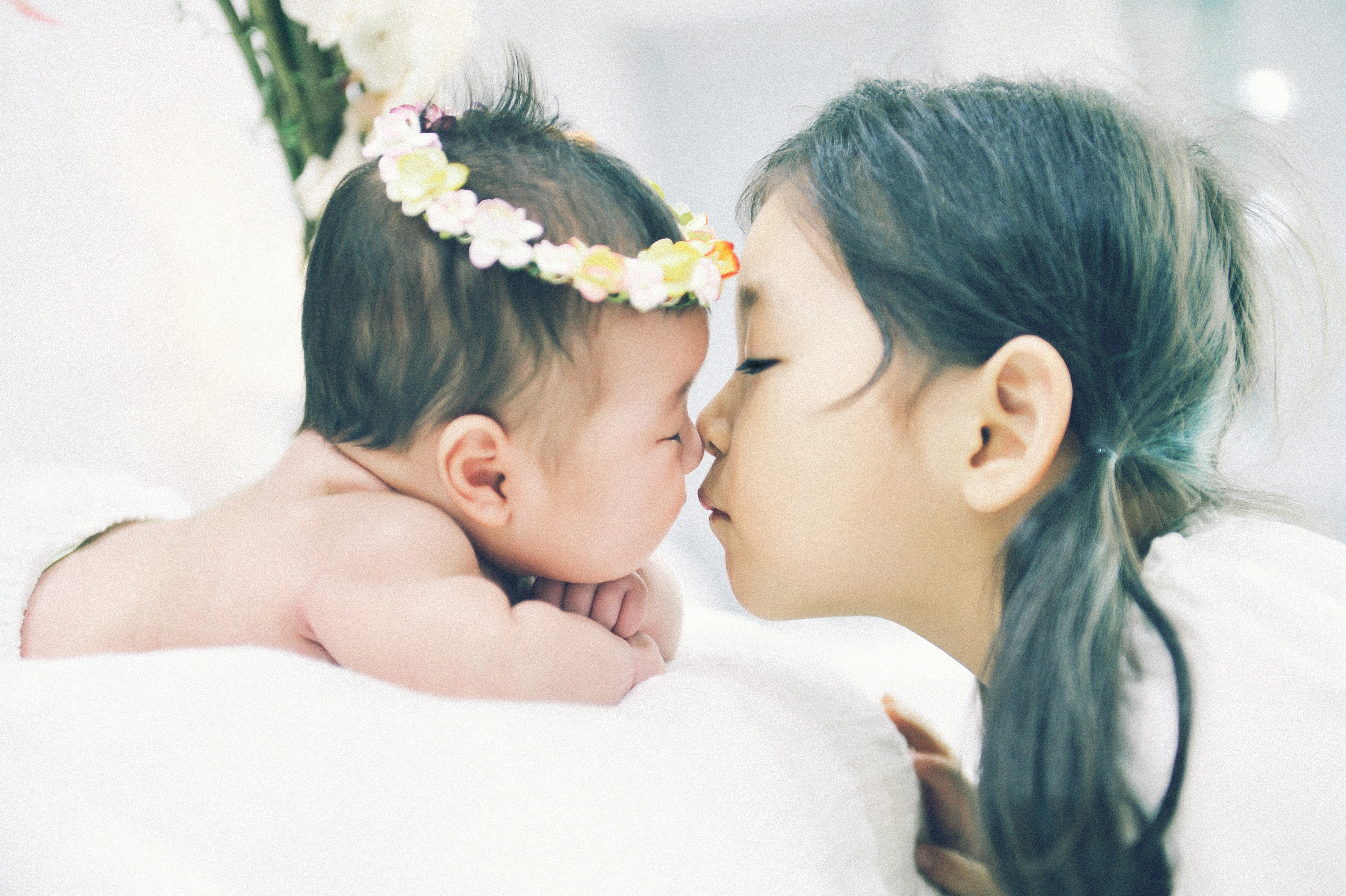 Infant nose-to-nose with older sister