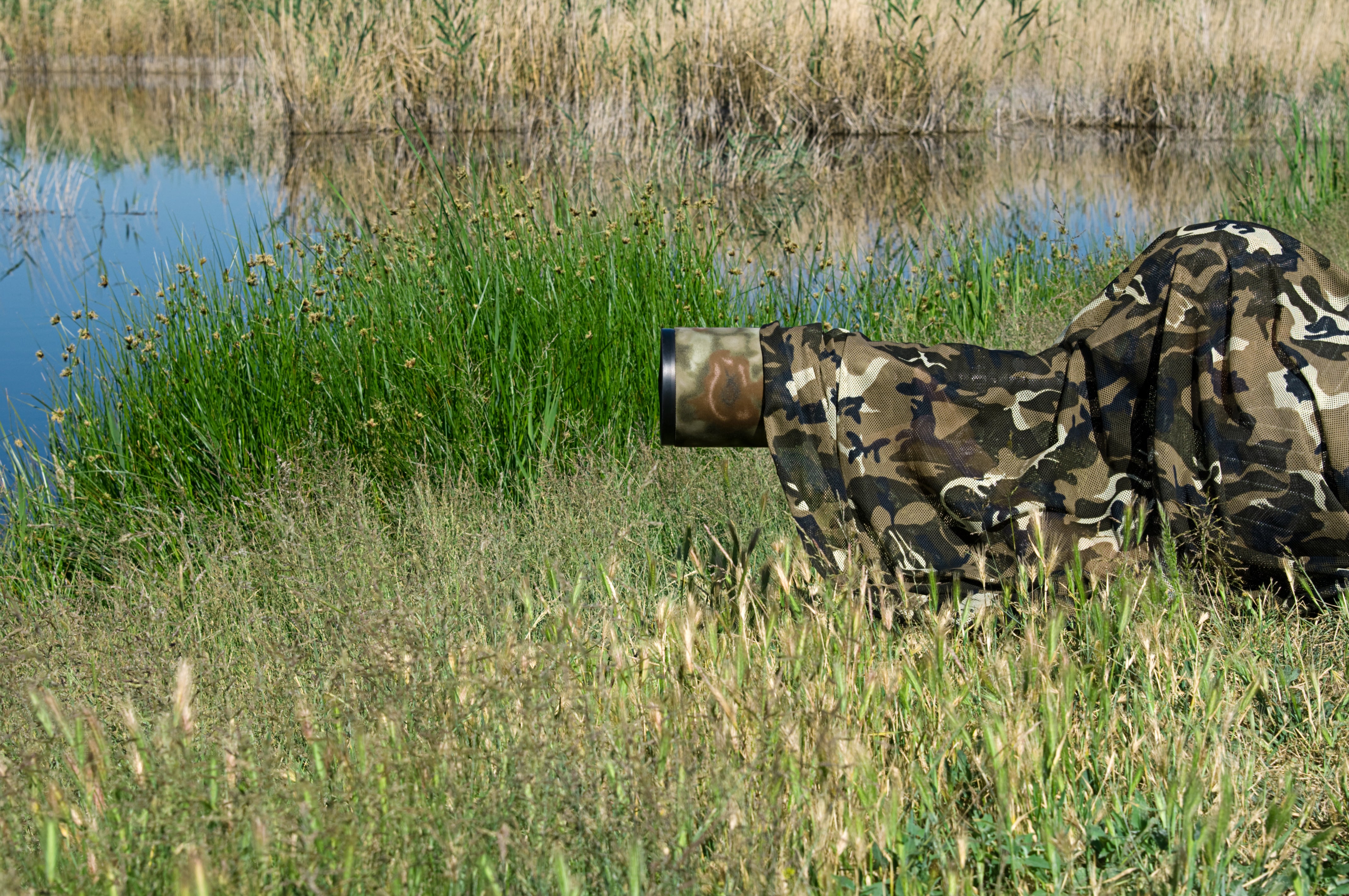 Professional photographer with camouflaged gear