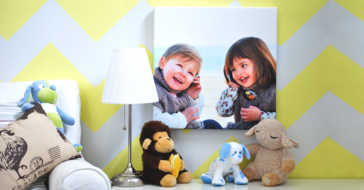 Photo of two children printed onto canvas and displayed in a bright, cheerful room.