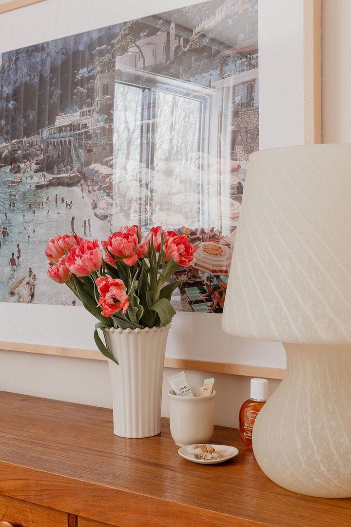 Posterjack natural wood picture frame displayed above a dresser. Photo captured by Posterjack customer, Ashley Izsak.