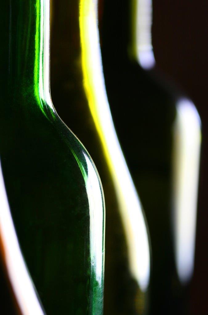 Close-up photo of coloured glass bottles illustrating the use of curved leading lines