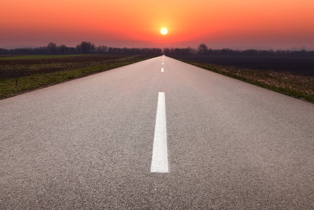 Endless road and sunset landscape using leading lines
