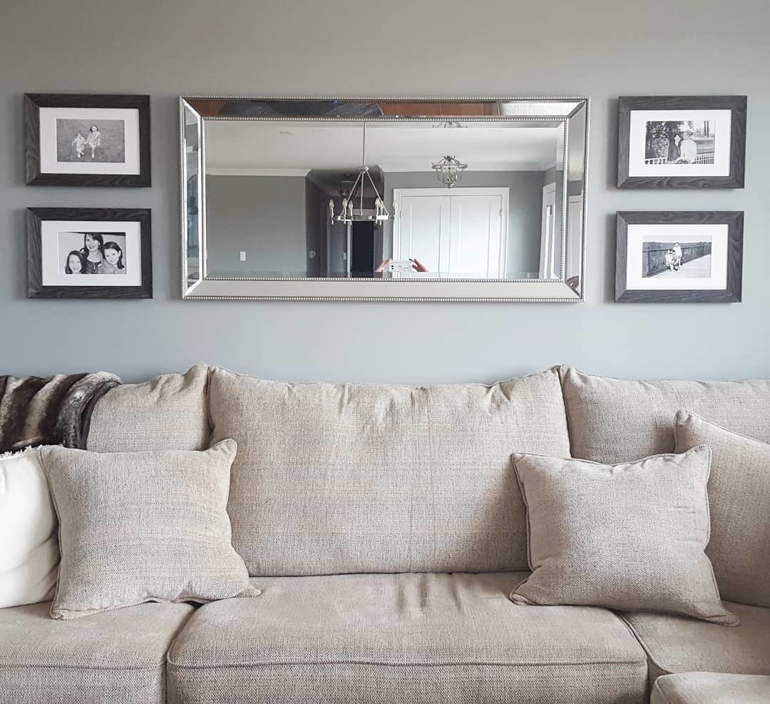 Living Room Gallery Wall with Four Photos and Large Mirror