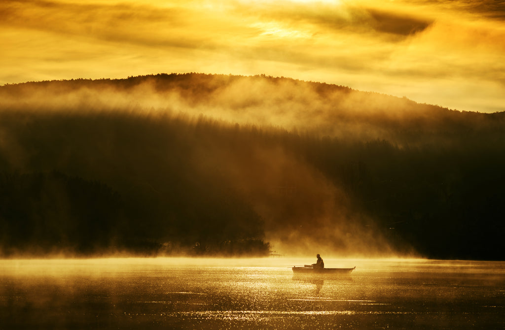 Beautiful landscape photo of a boat on a lake at sunrise