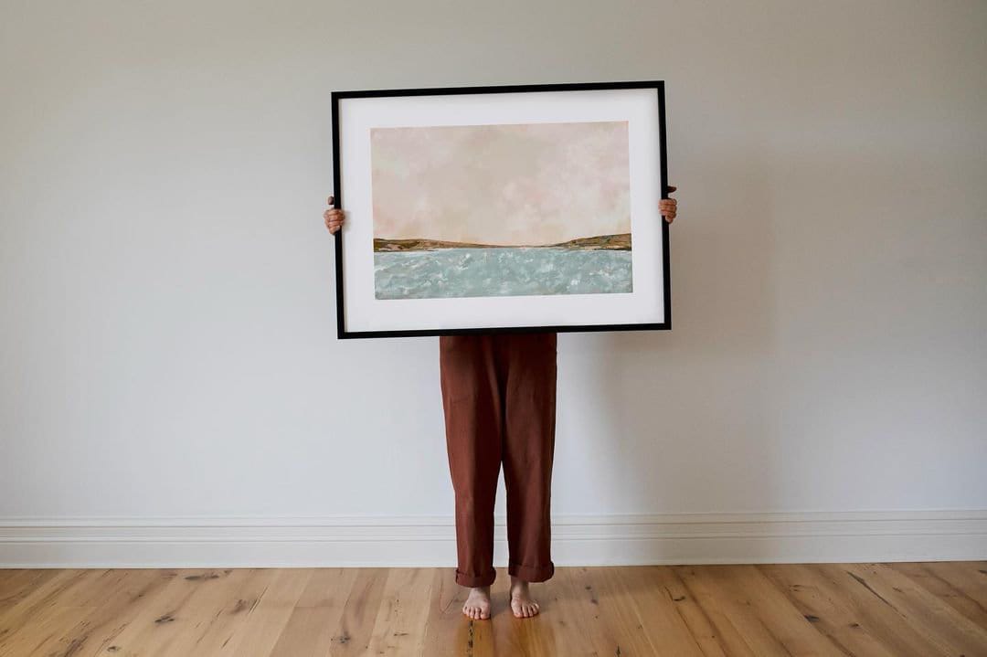 Canadian artist, Melissa Jenkins, holding large framed Fine Art Print.