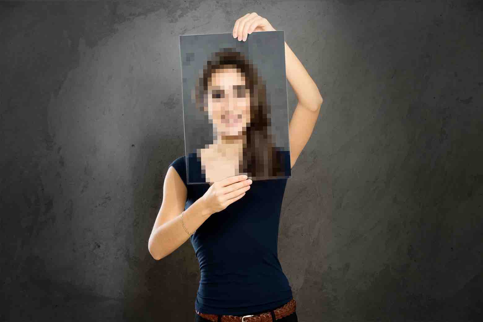 Woman Holding a Pixelated Portrait Photo