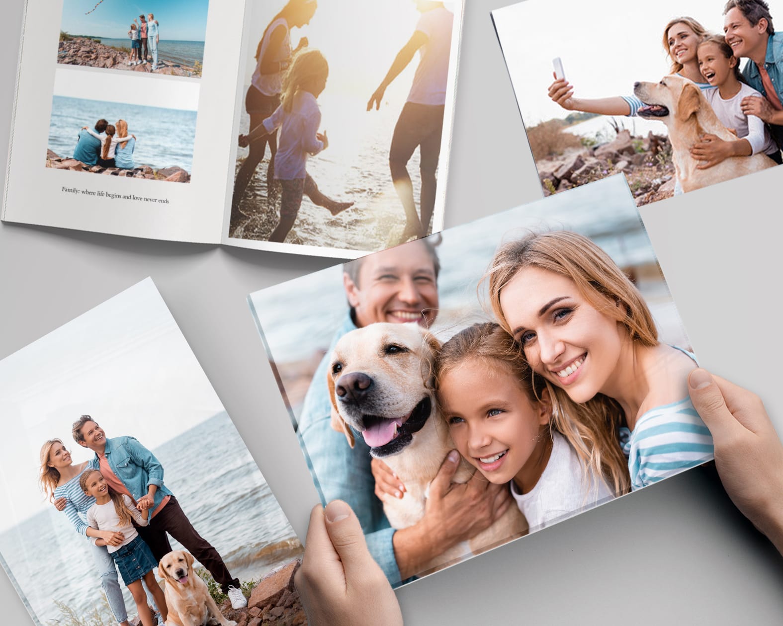 Person holding a print of a family photo with dog from a photoshoot at the beach
