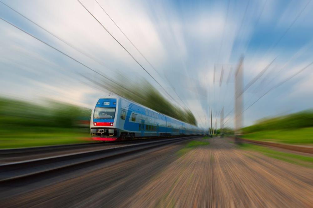 Train with motion blur on railroad tracks - example of diagonal leading lines in photography
