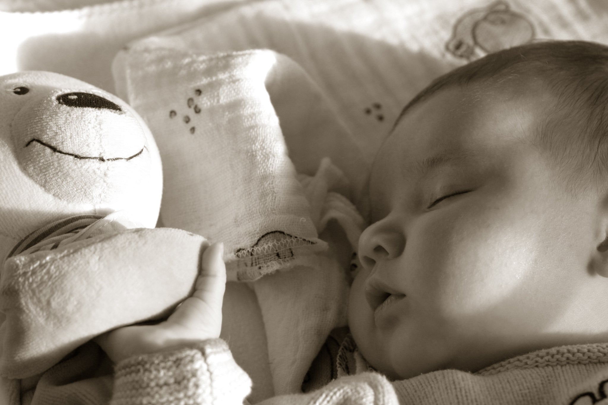 Sleeping baby with teddy bear