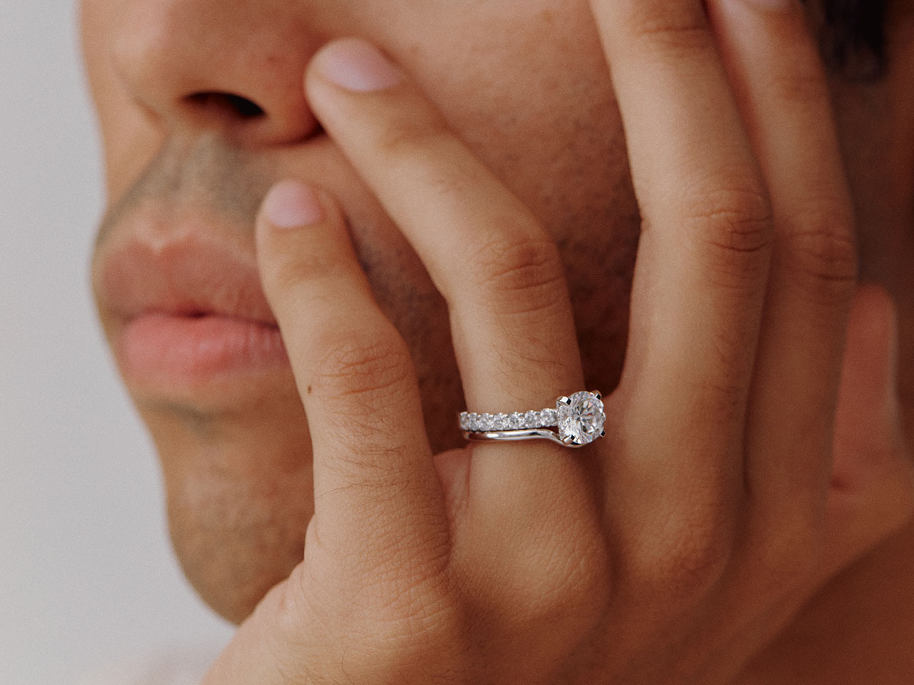 Model wearing The Eternity Solitaire with a cushion diamond paired with a curved ring