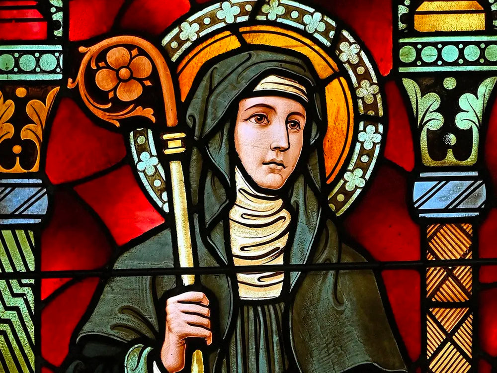 Stained glass portrait of St. Brigid of Kildaire, who asked St. Patrick to allow women to propose to men on leap day.