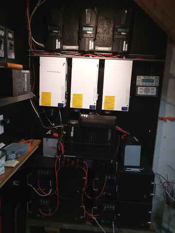 Three Midnite Classic controllers, three Midnite Solar Mini DC Disconnect boxes, Outback 3.6 kW inverter, and four 5kW LiFePO4 batteries