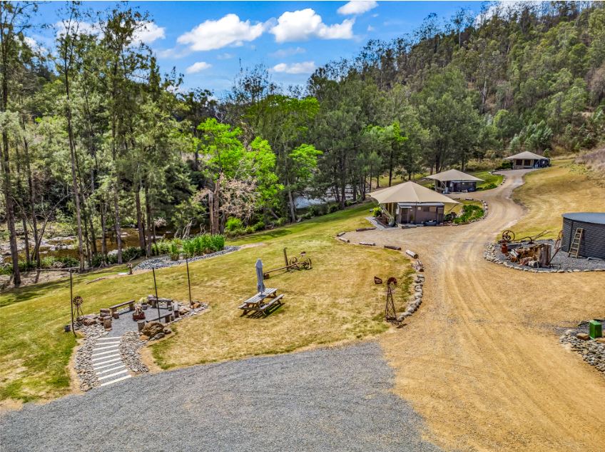 Ariel shot of Amaroo Escape landscape displayng the mannin river, a fore pit and the glamping tents