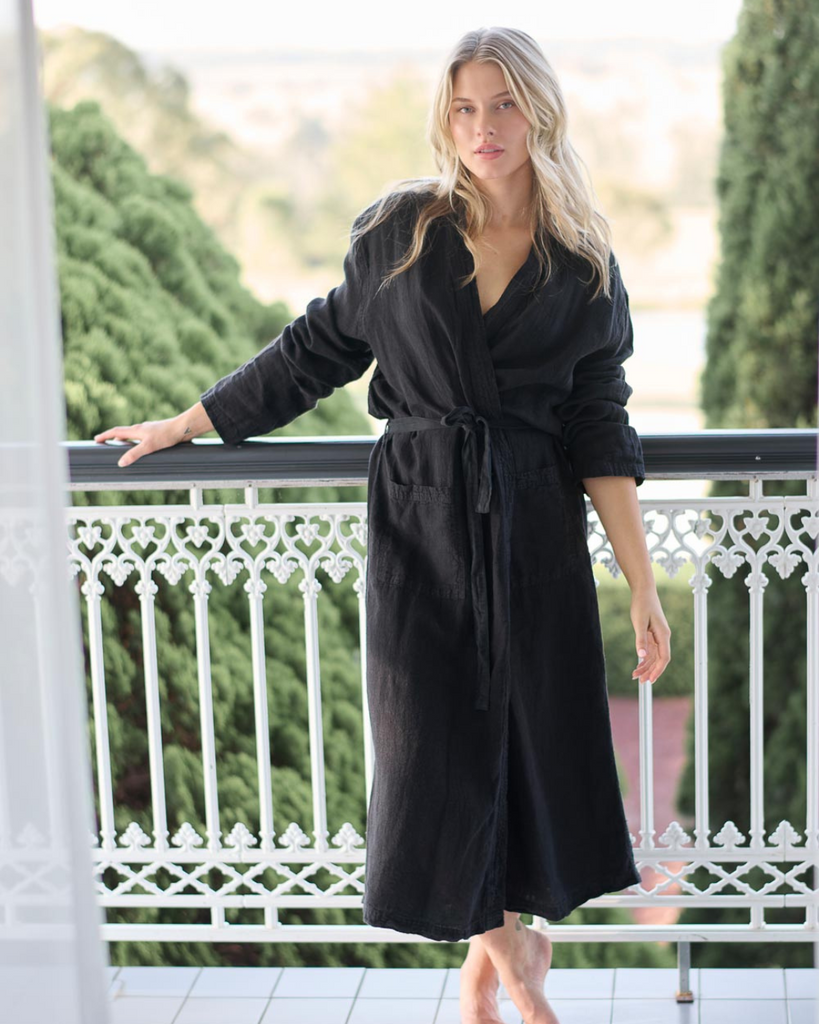 black linen tie up robe on a blonde girl located on a balcony