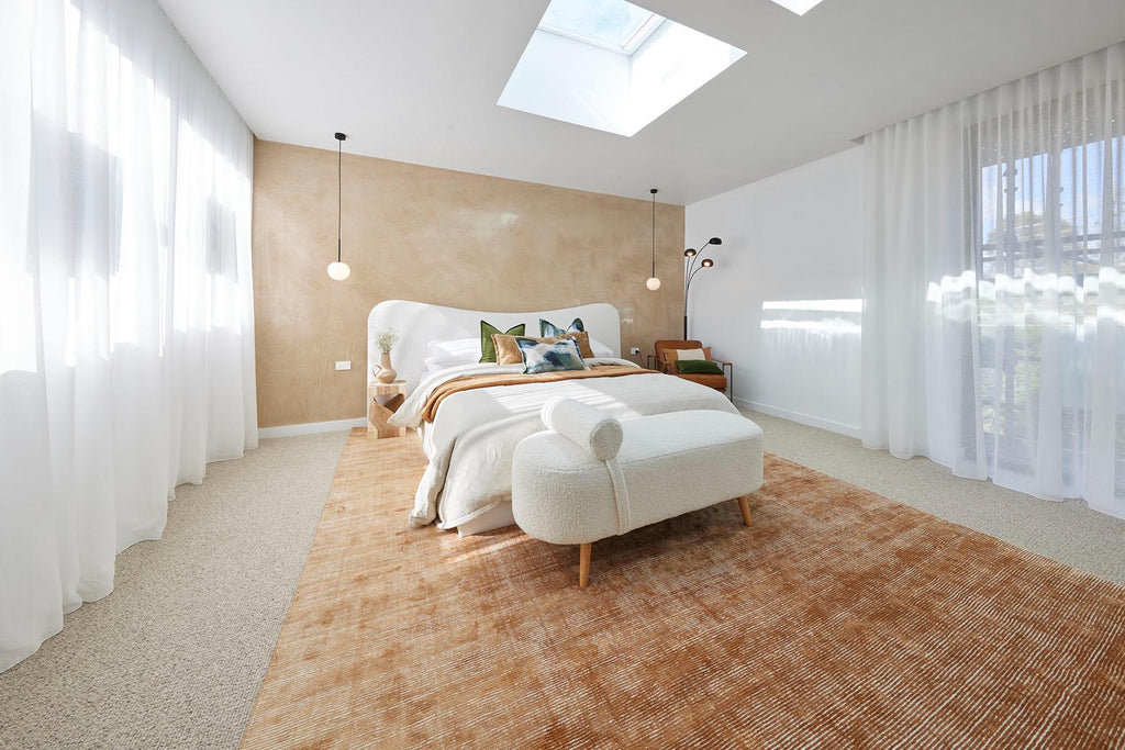 Kristy and Brett's master bedroom reveal on the Block was light and bright with overhead skylights and maximum light through windows on both sides with sheers topped iwth an orange rug