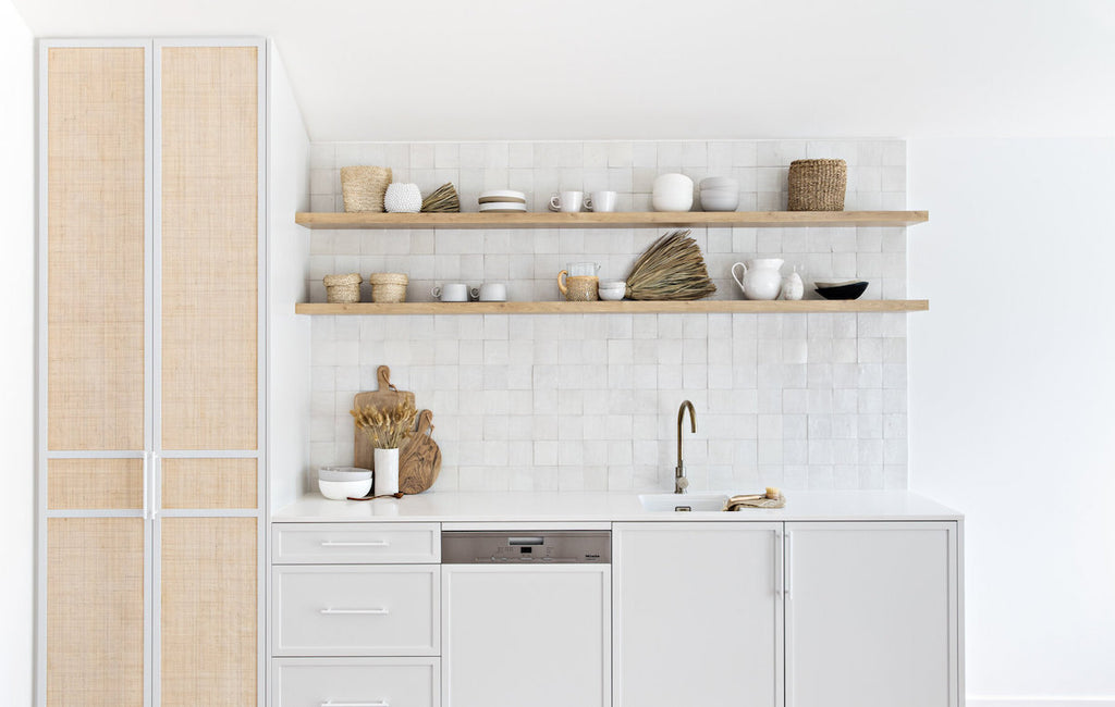 The rattan doors and tiled splash back in the kitchen of The Cape Beach House in Byron Bay