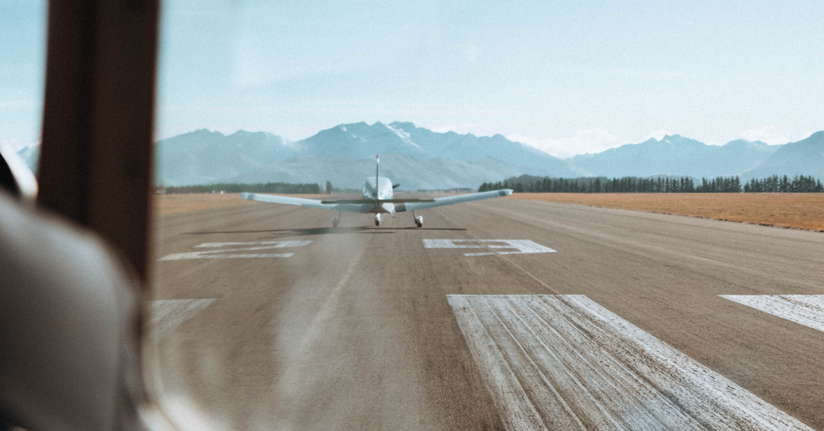 an airplane on the tarmac in the mountains