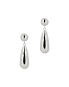 A pair of silver earrings on a green background