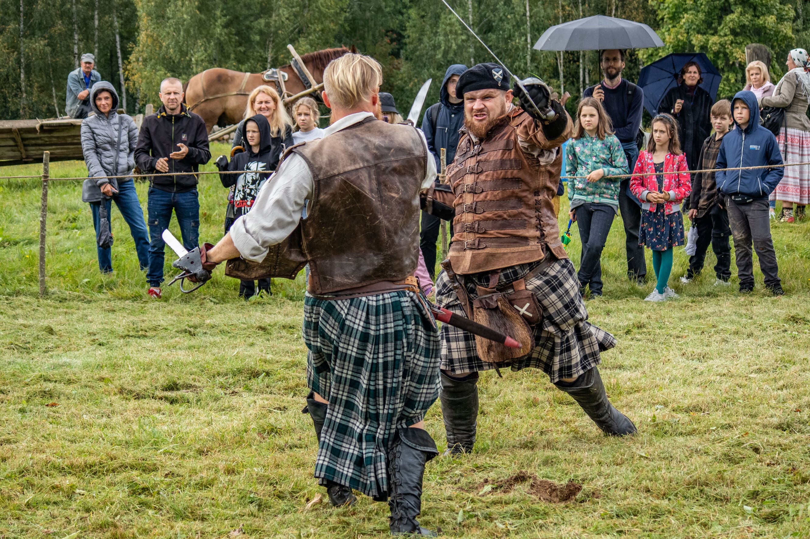 Two sword-fighting warriors in a historical reenactment