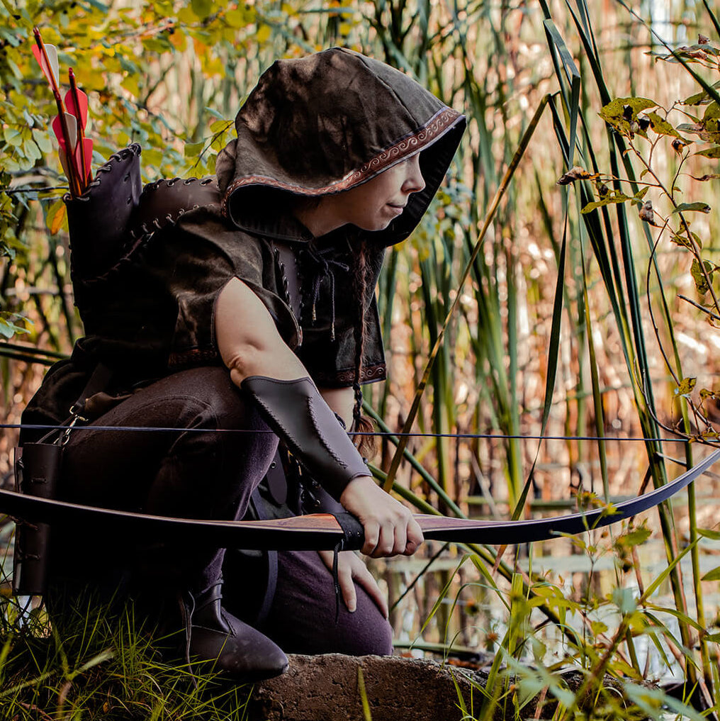 Larper holding a wooden bow in the forest