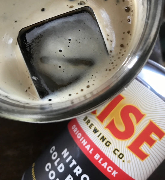 Iced RISE nitro cold brew coffee in a glass and in a can at a restaurant