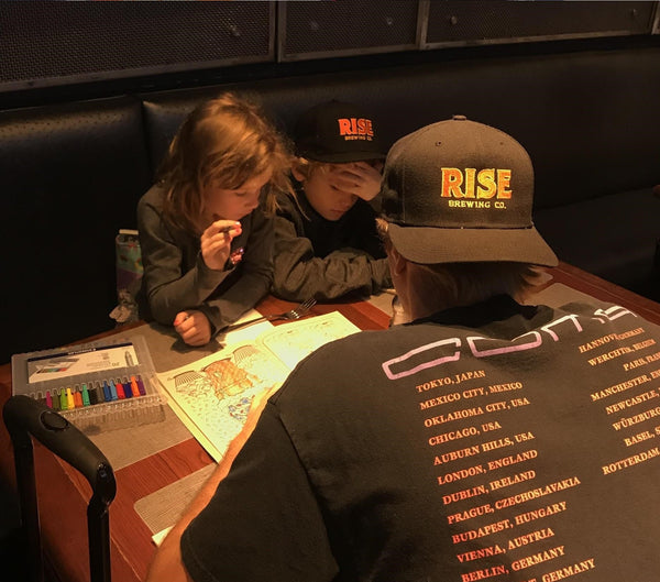 RISE Brewing Co. caps with father and kids